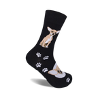 A pair of black crew socks with a tan Chihuahua and paw print design. 