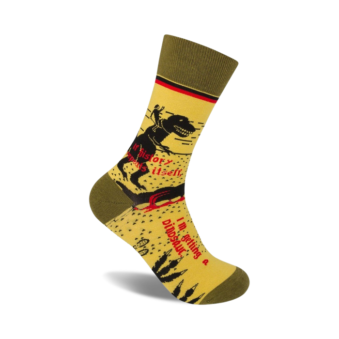 yellow crew socks with green cuff and red toe and heel. pattern of dinosaur skeleton riding a bicycle. text on socks: 