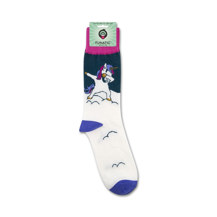 A pair of white socks with a pattern of blue clouds and a dabbing unicorn with a purple mane and tail. The socks have a purple toe and heel, and the Funatic logo is on the top of the sock.