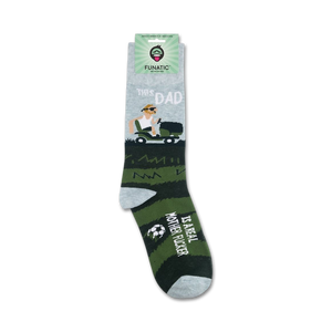 A pair of green and gray socks with the image of a man mowing a lawn on one sock and the words 