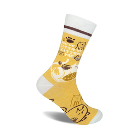 yellow crew socks with white toe, heel, and top; brown stripe around top of white; 'you've got to be kitten me' in brown text; cartoon cats in various poses  
