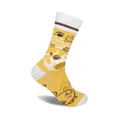 yellow crew socks with white toe, heel, and top; brown stripe around top of white; 'you've got to be kitten me' in brown text; cartoon cats in various poses  