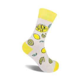 white crew socks with yellow toe, heel, and top featuring a pattern of lemons, lemon slices, and green leaves. the words 'suck it' are written in black on the yellow top of the sock.   