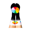 A person's legs with feet up, wearing the black Color Wheel crew socks. The heels show large color wheels, cuffs have smaller ones.