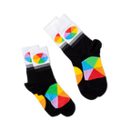 Two pairs of black crew socks with white cuffs and color wheel designs, lying flat and angled differently on a black background.