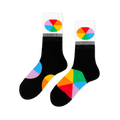 Pair of black crew socks with white cuffs featuring oval color wheel designs. Additional color wheel segments visible on the feet.