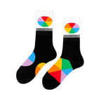 Pair of black crew socks with white cuffs featuring oval color wheel designs. Additional color wheel segments visible on the feet.