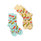Two pairs of pop art crew socks: one light blue and one light yellow, both featuring red soup cans and yellow bananas, against a black background.