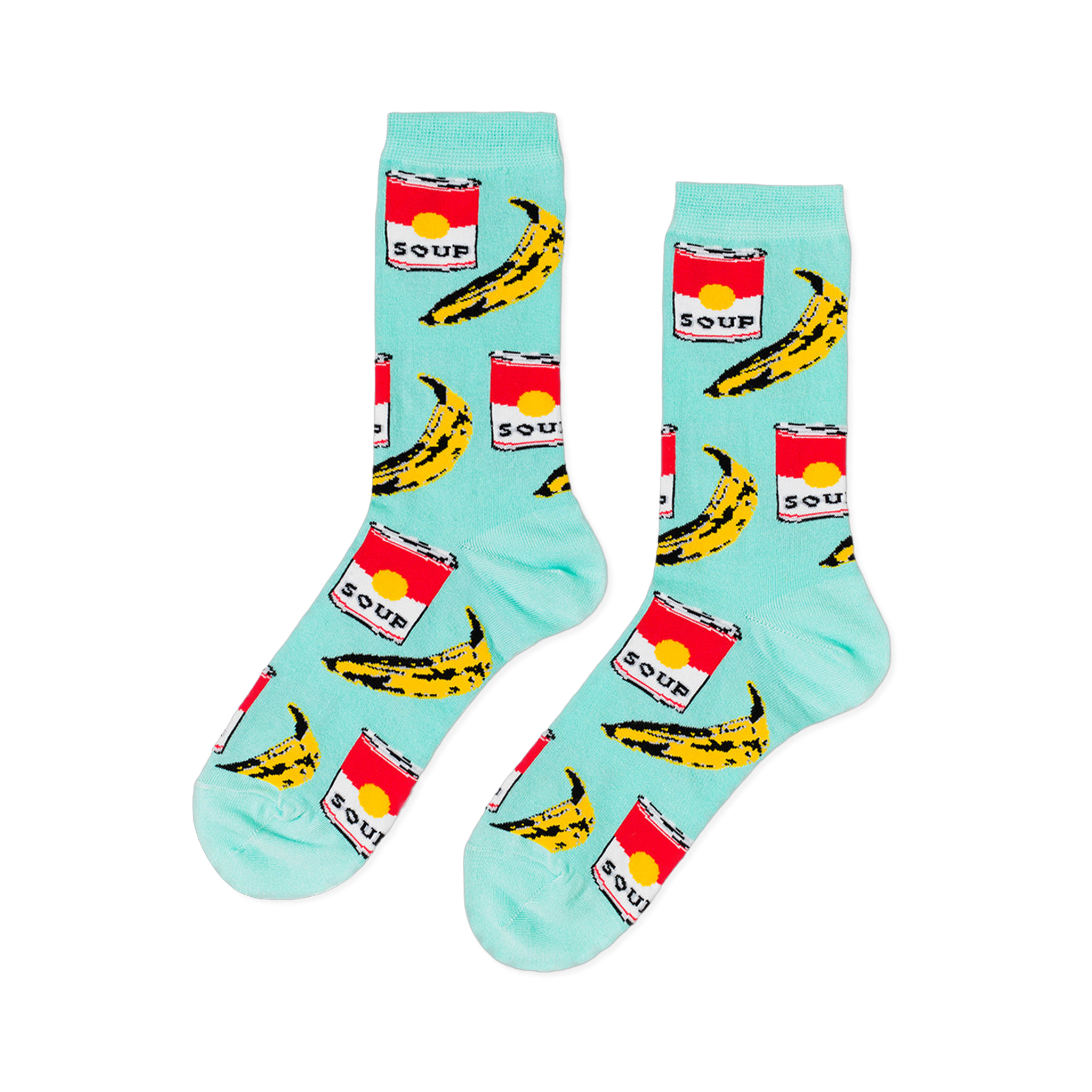 A pair of light blue crew socks with a repeating pop art pattern of red soup cans and yellow bananas, laid flat against a black background.