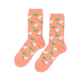 Pair of crew socks in peachy-orange. Patterned with green cannabis leaves and lit joints with white smoke.