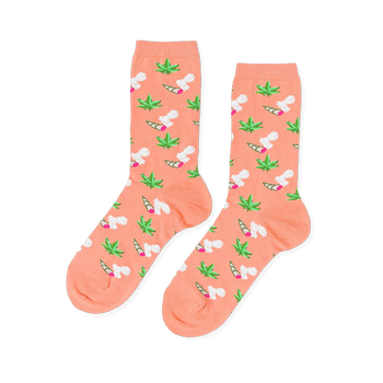 Pair of crew socks in peachy-orange. Patterned with green cannabis leaves and lit joints with white smoke.