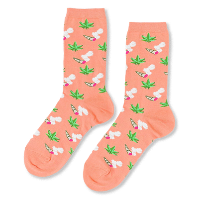 Pair of crew socks in peachy-orange. Patterned with green cannabis leaves and lit joints with white smoke.