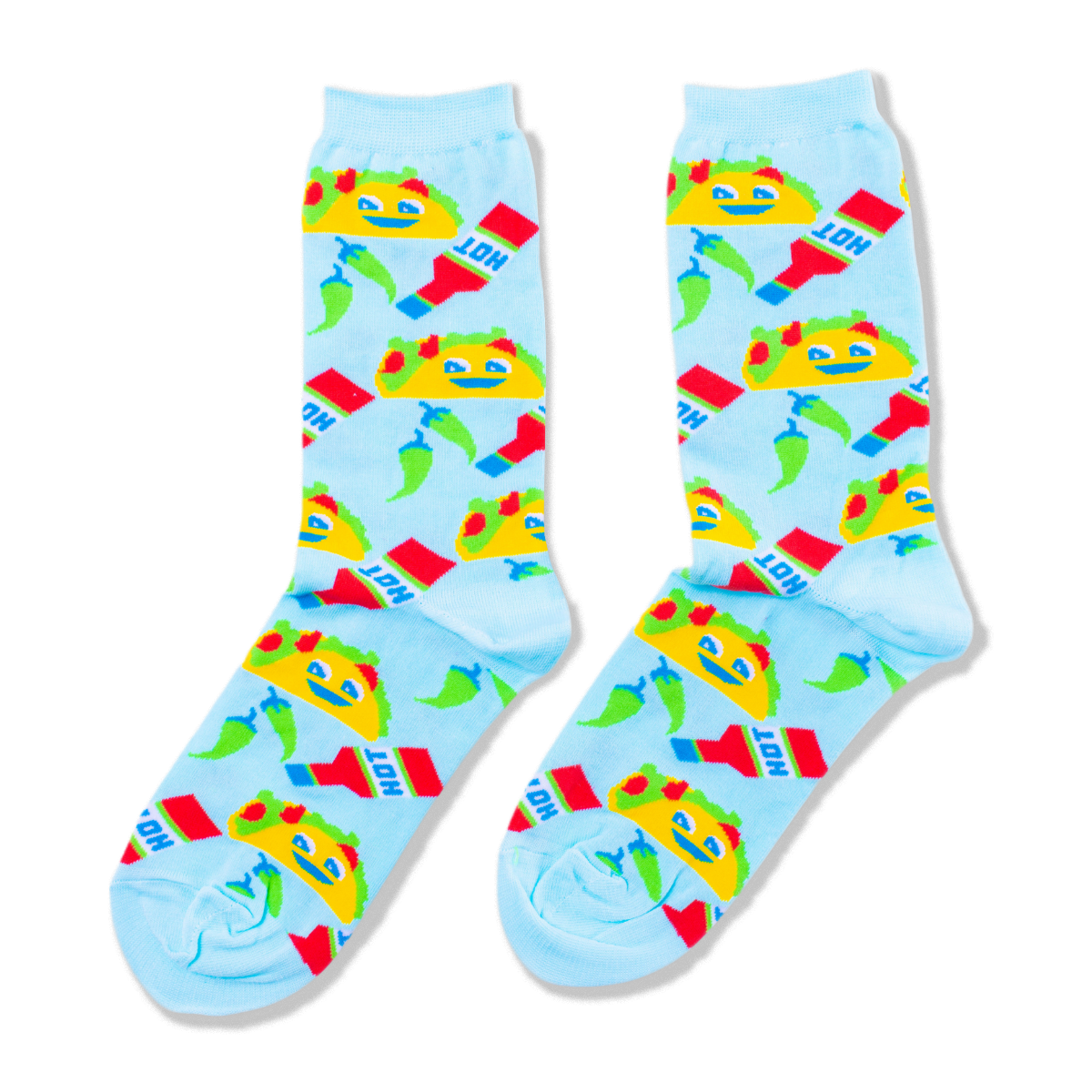 A pair of light blue crew socks covered in a pattern of yellow smiling tacos, red hot sauce bottles, and green chili peppers.