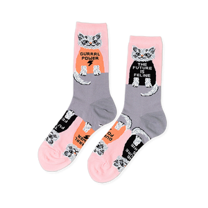 Pair of crew socks in pink and grey, patterned with white cats wearing black and orange shirts with 