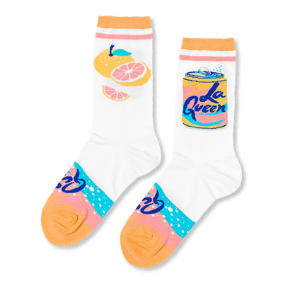 Pair of white crew socks. One has yellow and pink grapefruit, the other a yellow "La Queen" soda can. Pink/blue pattern on heel, orange cuffs/toes.