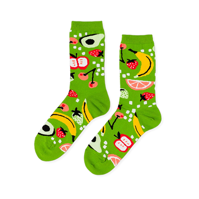 Pair of crew socks in bright lime green, patterned with yellow bananas, red strawberries, apples, avocados, cherries, and grapefruit slices.