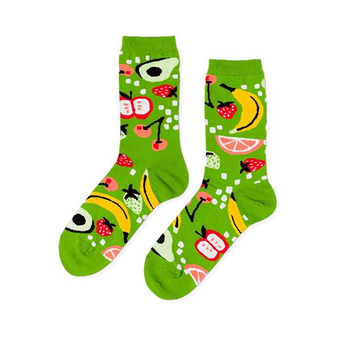 Pair of crew socks in bright lime green, patterned with yellow bananas, red strawberries, apples, avocados, cherries, and grapefruit slices.