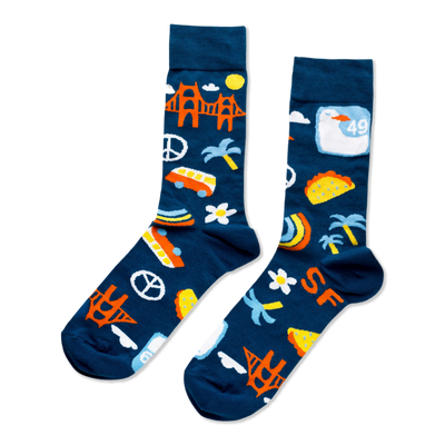 A pair of dark blue crew socks featuring orange Golden Gate Bridges, yellow suns, white clouds, green palm trees, "SF" text, and tacos.