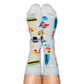 A person wearing light grey NYC patterned socks with their legs pointing straight up against a black background.