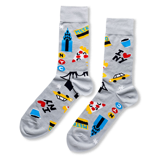 Light grey crew socks with a colorful NYC pattern featuring taxis, smiling pizza slices, blue towers, and I Love NY text.