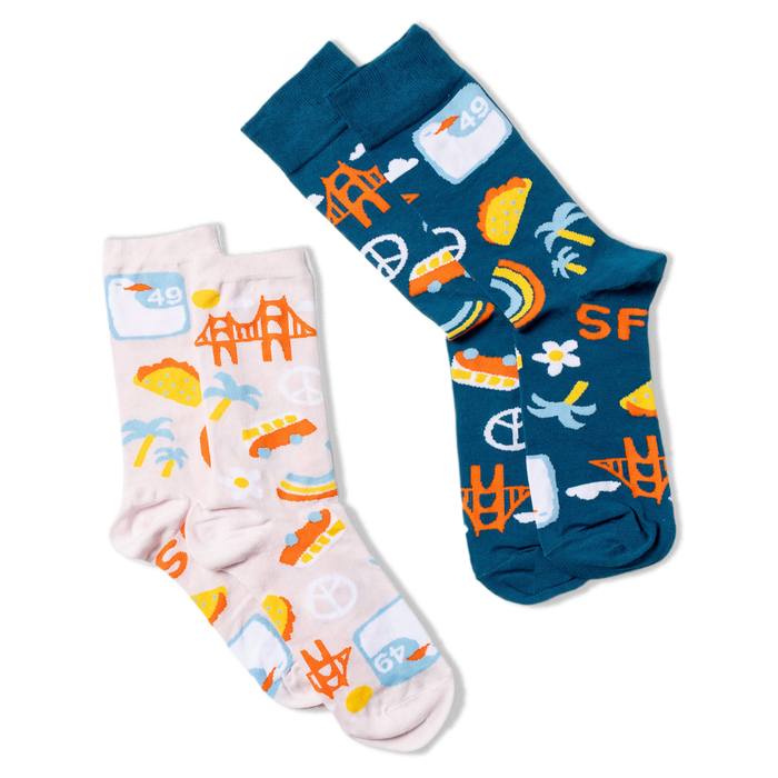 Two pairs of crew socks, laid flat. One lavender pair with SF icons, and one dark blue pair with matching SF icon designs.