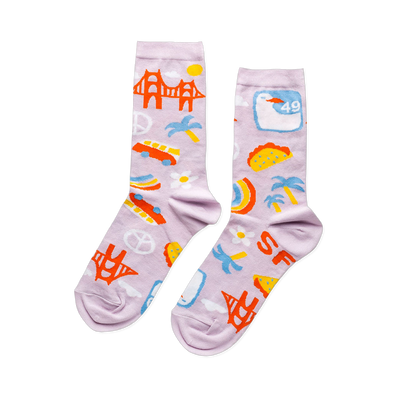 A pair of lavender crew socks with a San Francisco theme, featuring the Golden Gate Bridge, cars, tacos, peace signs, and 'SF' letters.