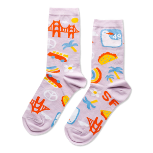 A pair of lavender crew socks with a San Francisco theme, featuring the Golden Gate Bridge, cars, tacos, peace signs, and 'SF' letters.