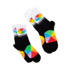 Two pairs of black crew socks with white cuffs and colorful color wheel segments, laid flat on a white surface.