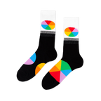 Pair of black crew socks with white cuffs. Each cuff has an oval, rainbow-segmented color wheel design. Large color wheel segments on the foot.