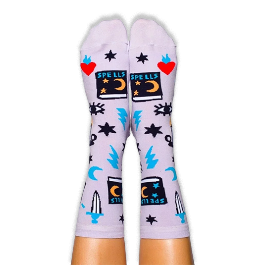 Person wearing light purple socks featuring black spellbooks, red flaming hearts, blue lightning bolts, and all-seeing eyes.