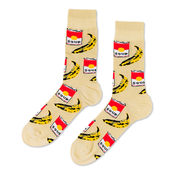 Pair of crew socks with a cream background, featuring a repeating pattern of red soup cans and yellow bananas.