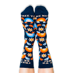 Legs wearing navy blue crew socks showing a colorful turtle and daisy pattern with text at the top and toes.