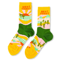 Yellow and green crew socks reading West Coast with palm trees and a sunset, and Best Coast with pine trees and mountains.