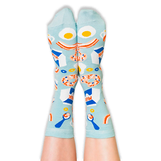 Front view of a person wearing light blue breakfast socks with their legs extended upwards against a dark background.