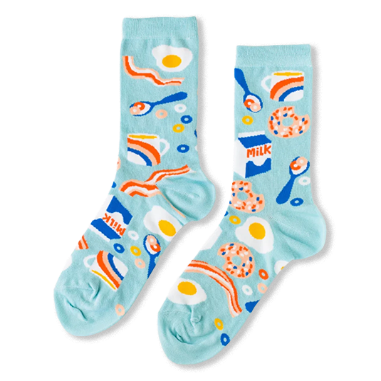 Light blue crew socks with a breakfast pattern showing fried eggs, bacon, milk cartons, donuts, and coffee cups.