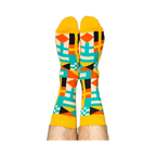 Person's legs wearing the vibrant nautical flag socks, heels up against a white background.