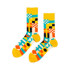 Pair of crew socks with a vibrant geometric nautical flag pattern in yellow, blue, orange, black, and white.