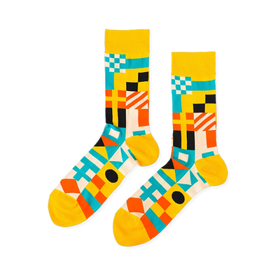 Pair of crew socks with a vibrant geometric nautical flag pattern in yellow, blue, orange, black, and white.