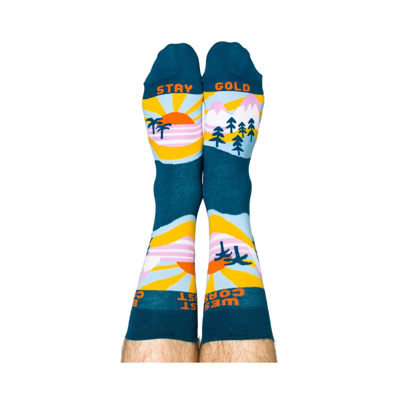 A person wearing the West Coast Best Coast socks, soles up. The 'STAY GOLD' text is visible on the bottoms.
