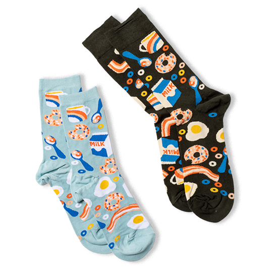 Two pairs of breakfast pattern crew socks: one dark background, one light blue, laid diagonally on a white surface.