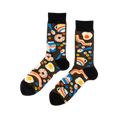 Pair of crew socks with a black background covered in a pattern of fried eggs, bacon, donuts, milk cartons, and coffee cups.