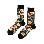 Pair of crew socks with a black background covered in a pattern of fried eggs, bacon, donuts, milk cartons, and coffee cups.