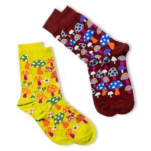 Two pairs of socks; the main mushroom pattern pair (right) and a yellow-green pair with mushrooms and flowers (left).