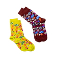 Two pairs of socks; the main mushroom pattern pair (right) and a yellow-green pair with mushrooms and flowers (left).