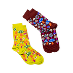 Two pairs of socks; the main mushroom pattern pair (right) and a yellow-green pair with mushrooms and flowers (left).