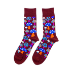 Pair of crew socks with a repeating pattern of colorful mushrooms on a dark red-brown background. Mushrooms are blue, orange, pink, white.