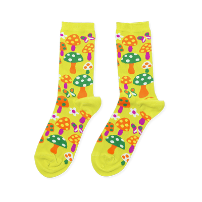Pair of bright yellow crew socks with an all-over pattern of orange, green, and purple mushrooms, colorful butterflies, and white flowers.