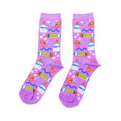 Pair of lavender crew socks with a repeating pattern of white glue bottles, orange scissors, yellow pencils, and blue wavy lines.