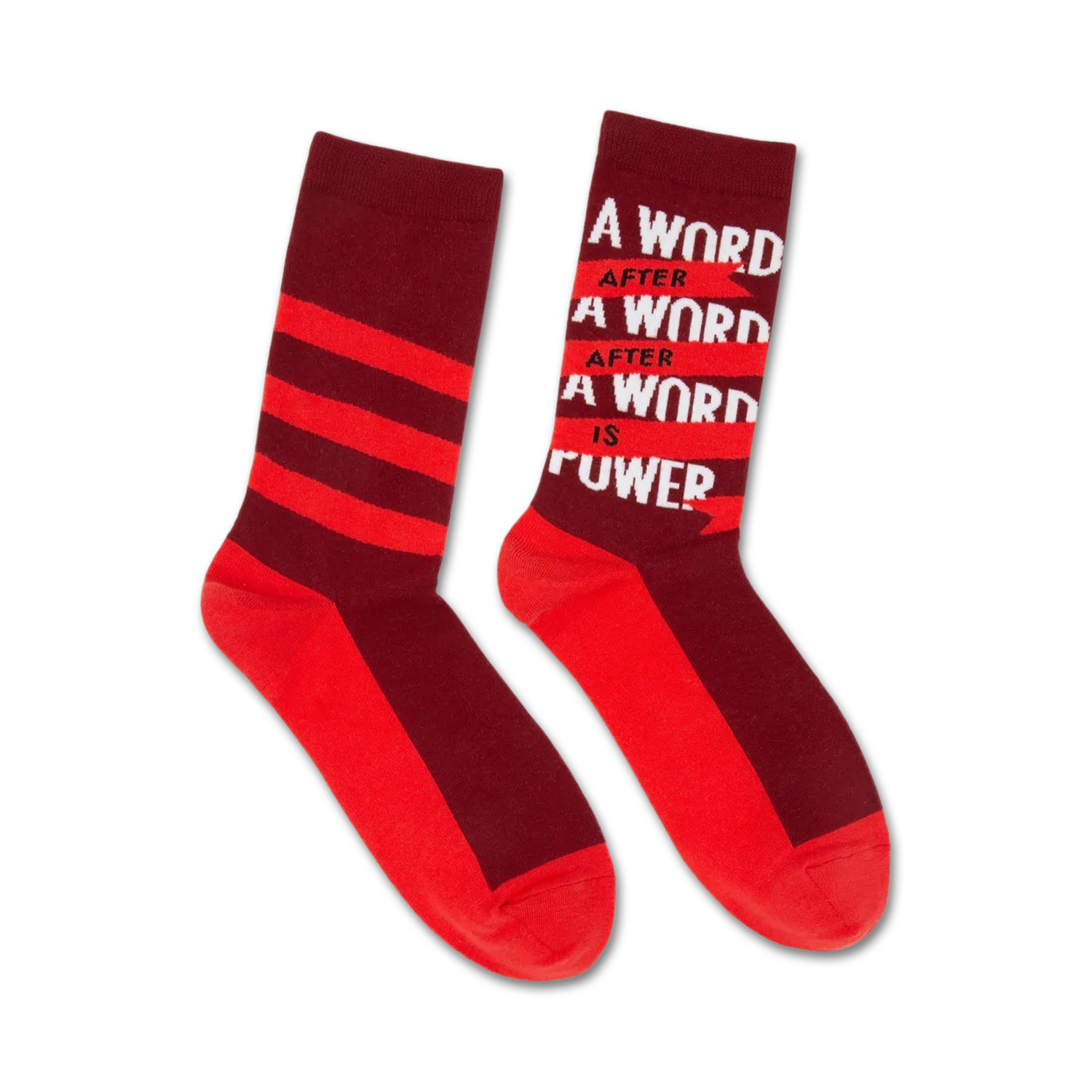 Pair of crew socks in red and burgundy. One sock features horizontal stripes, the other displays 'A word after a word after a word is power'.