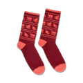 Pair of burgundy crew socks with a playful pattern of coral cats and stacks of books. 